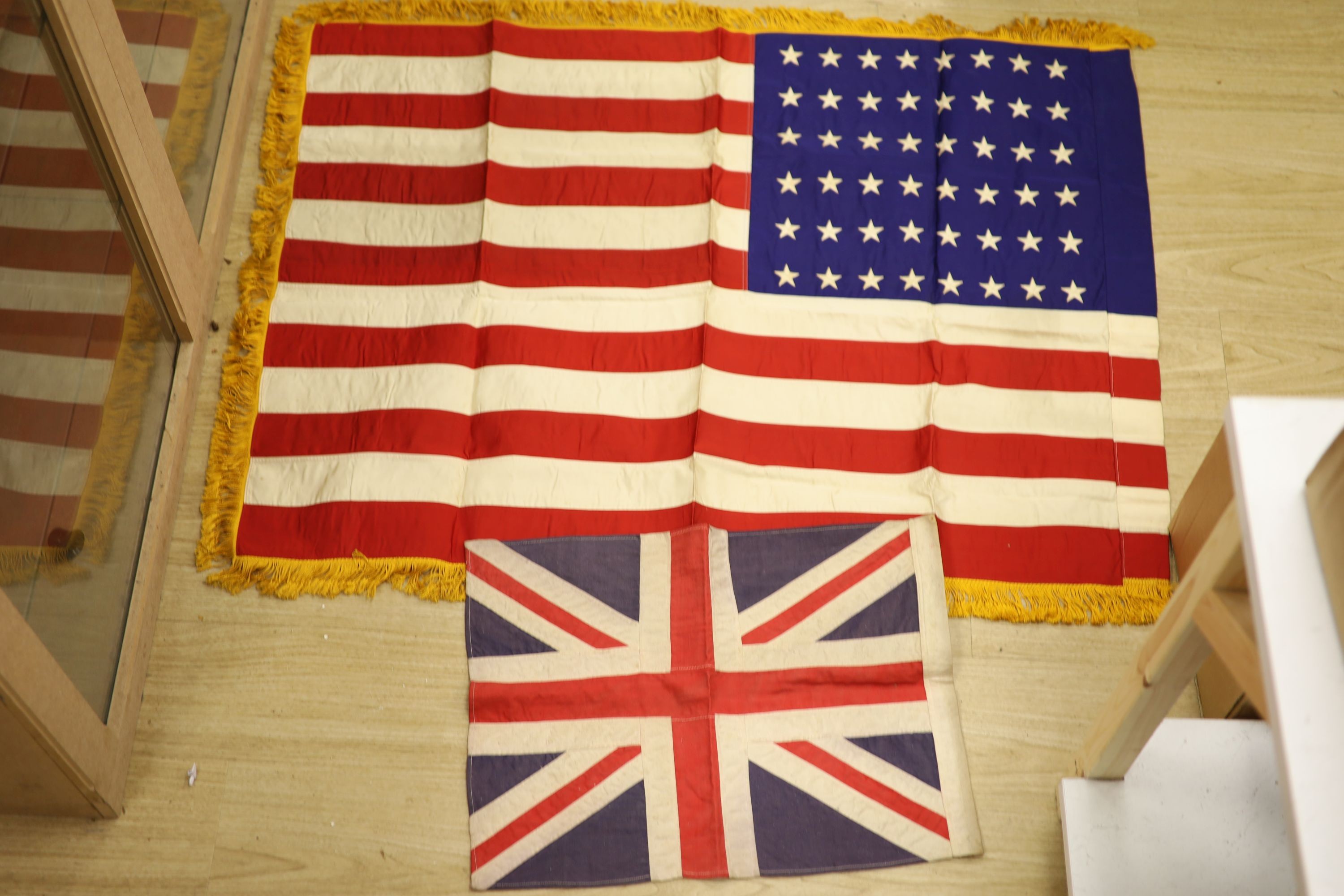 A military Union Flag and American Flag, sheepskin jerkin, 2nd war medal to S/SJT W L Blissett and ISM to Adelina Emily Prince